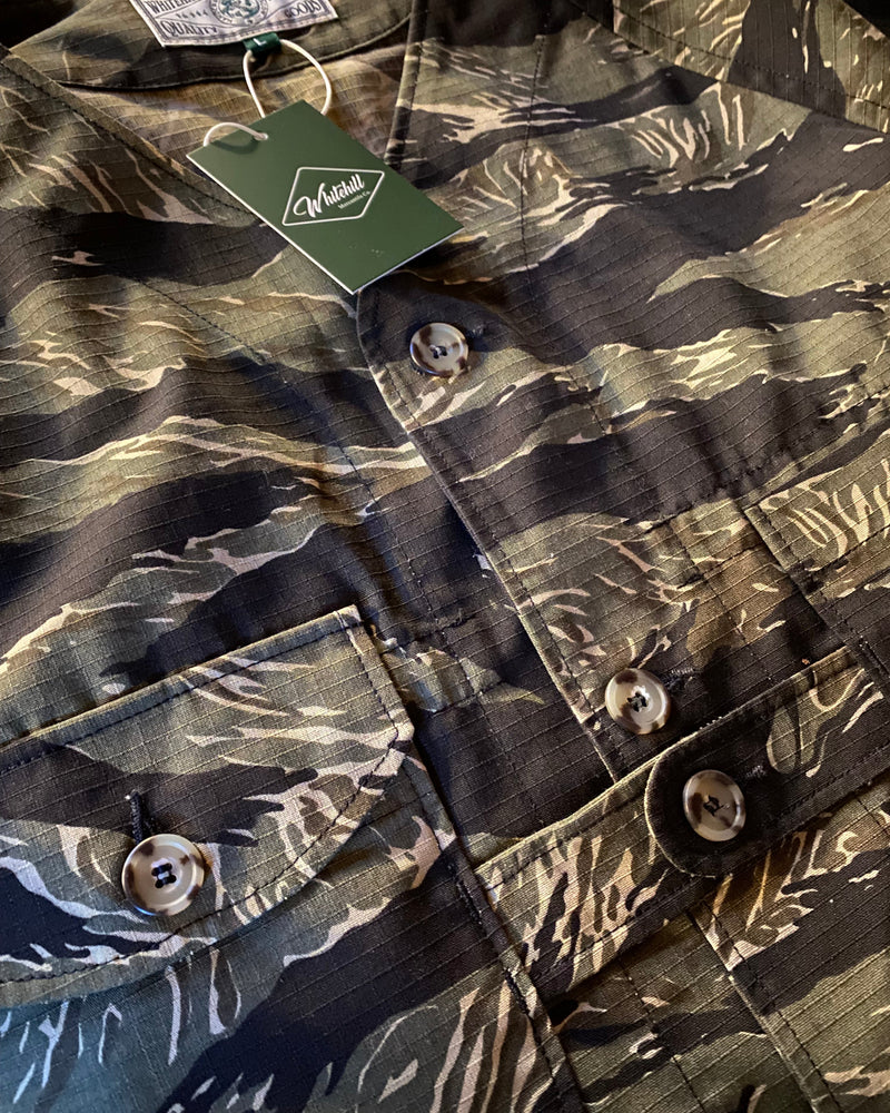 Camouflage print shirt with buttons and a visible brand tag.